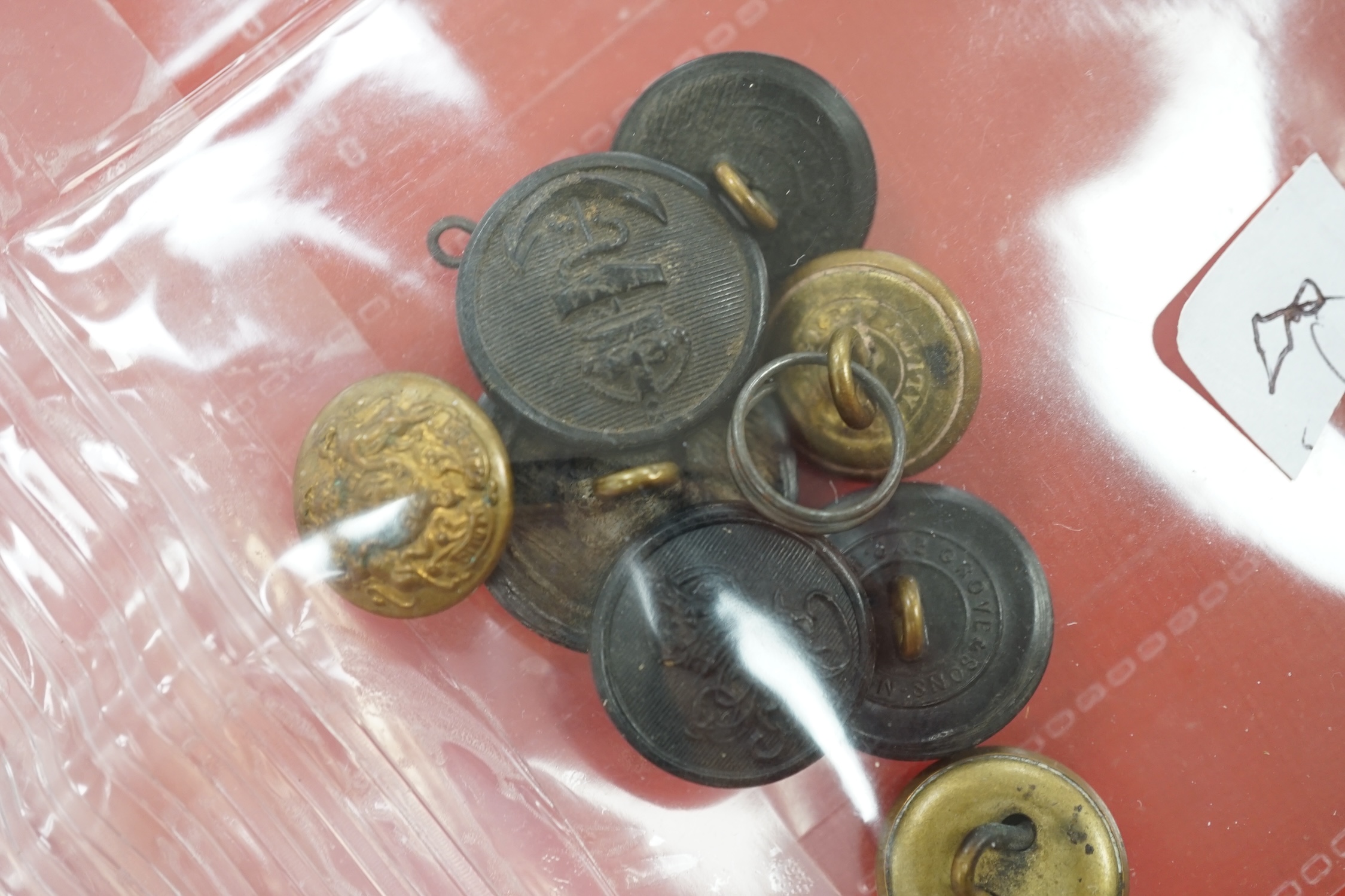 A collection of Police badges and buttons, including to Eastbourne Borough Police helmet plates, Eastbourne Fire Brigade uniform buttons, Royal Navy buttons, a whistle, etc. together with a batten decorated with beadwork